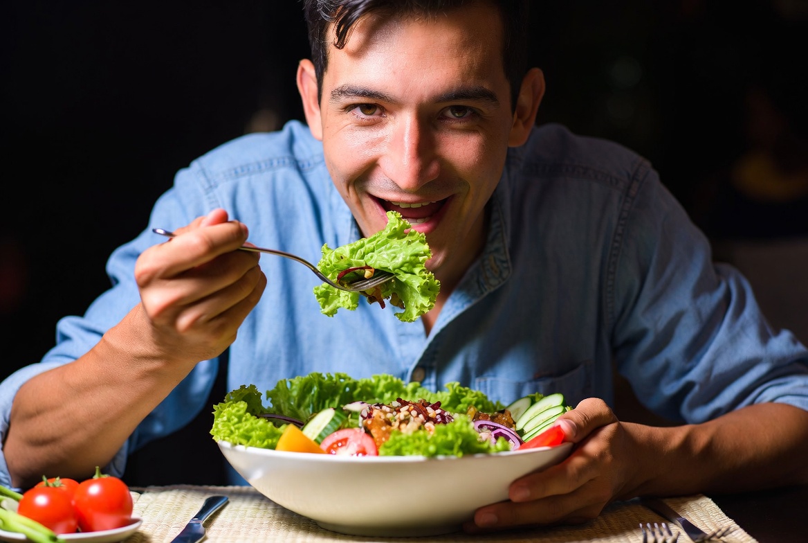Person happily eating enormous salad